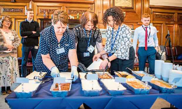 Some of the new frozen school meals are prepared for a taste test.