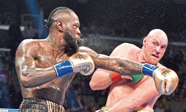 Deontay Wilder and Tyson Fury during the WBC Heavyweight Championship bout at the Staples Center in Los Angeles. Picture: Lionel Hahn/PA Wire