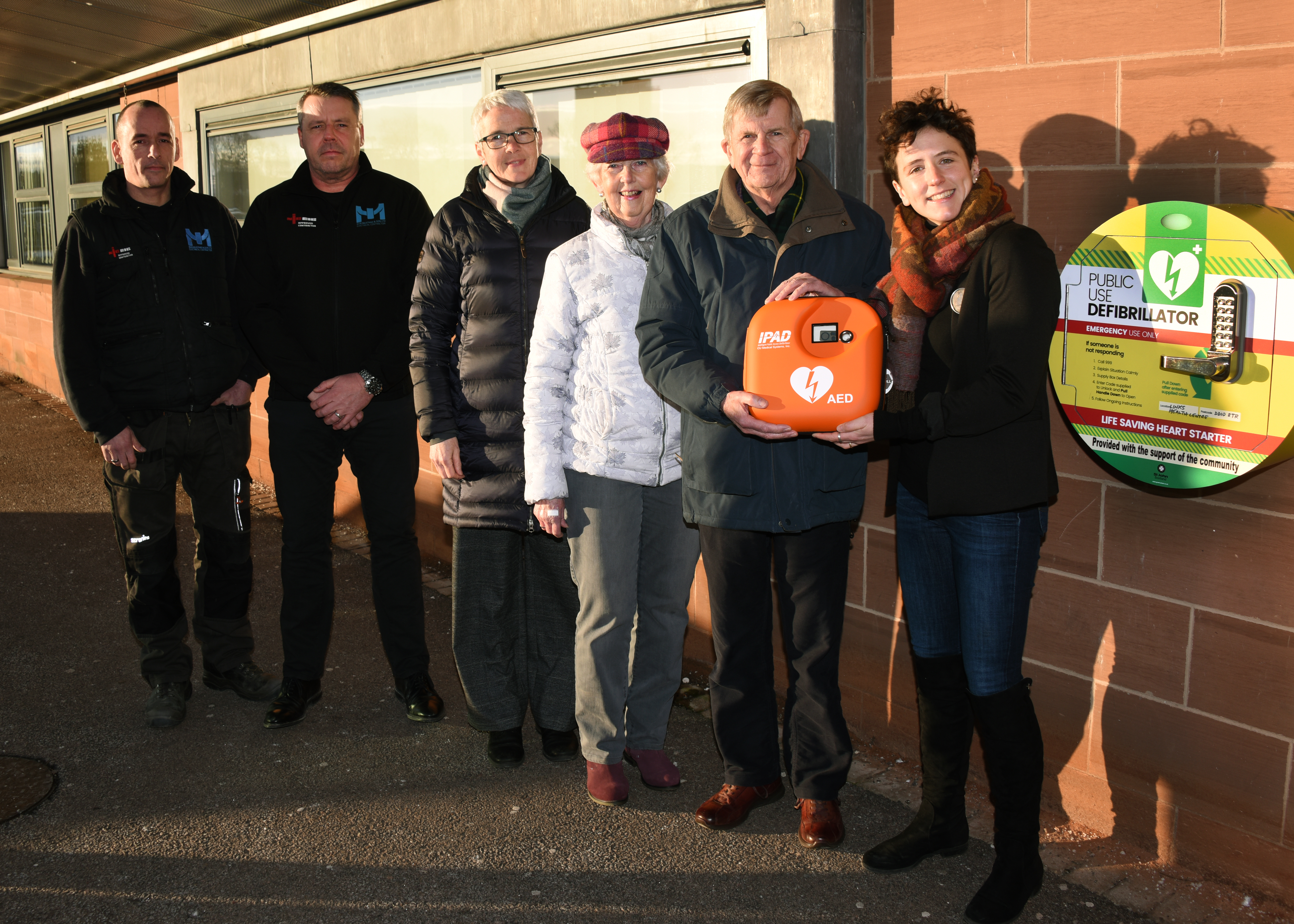 From right: Mairi Gougeon, David Milne (Rotary), Susan Coull (Inner Wheel), Melanie Cargill (First Responder),  electricians Bill Mustard and Chris Taylor