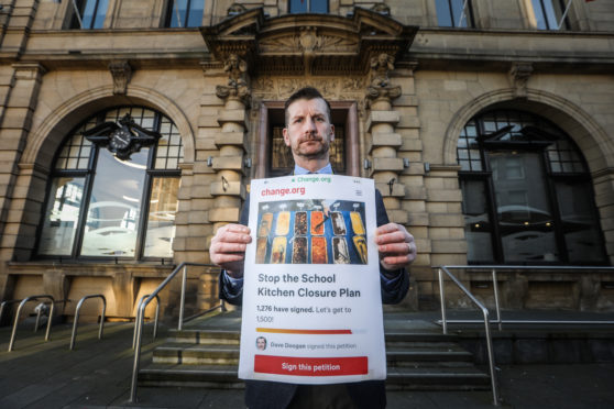 Councillor Dave Doogan with his petition against frozen school meals.