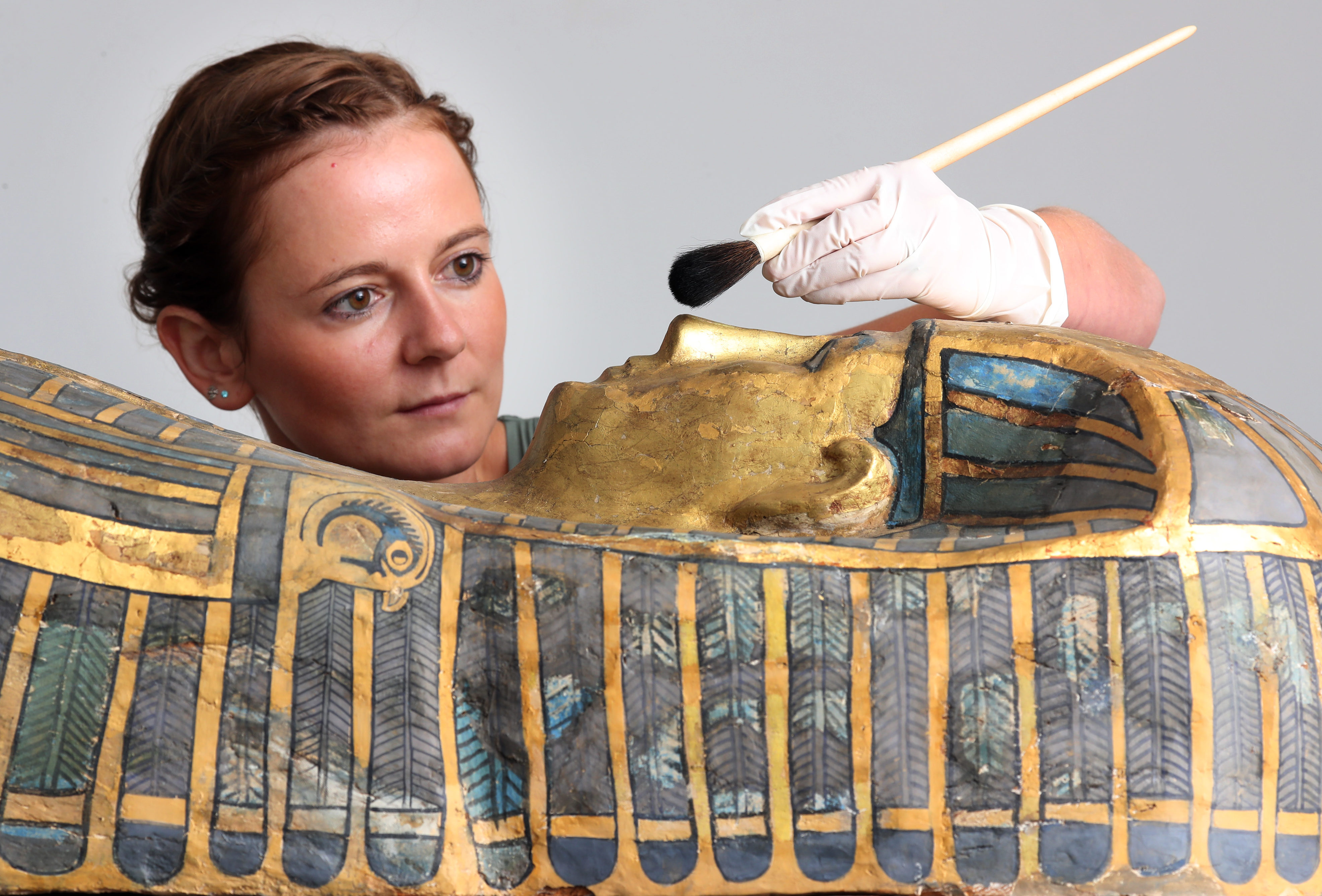 Assistant conservator Bethan Bryan works on the Qurna coffin.