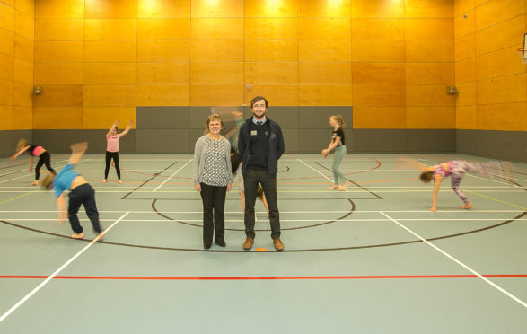 Local gymnasts try out the new sports hall flooring watched on by Cllr Judy Hamilton with Scott Bramall, duty manager, Fire Sports and Leisure Trust.