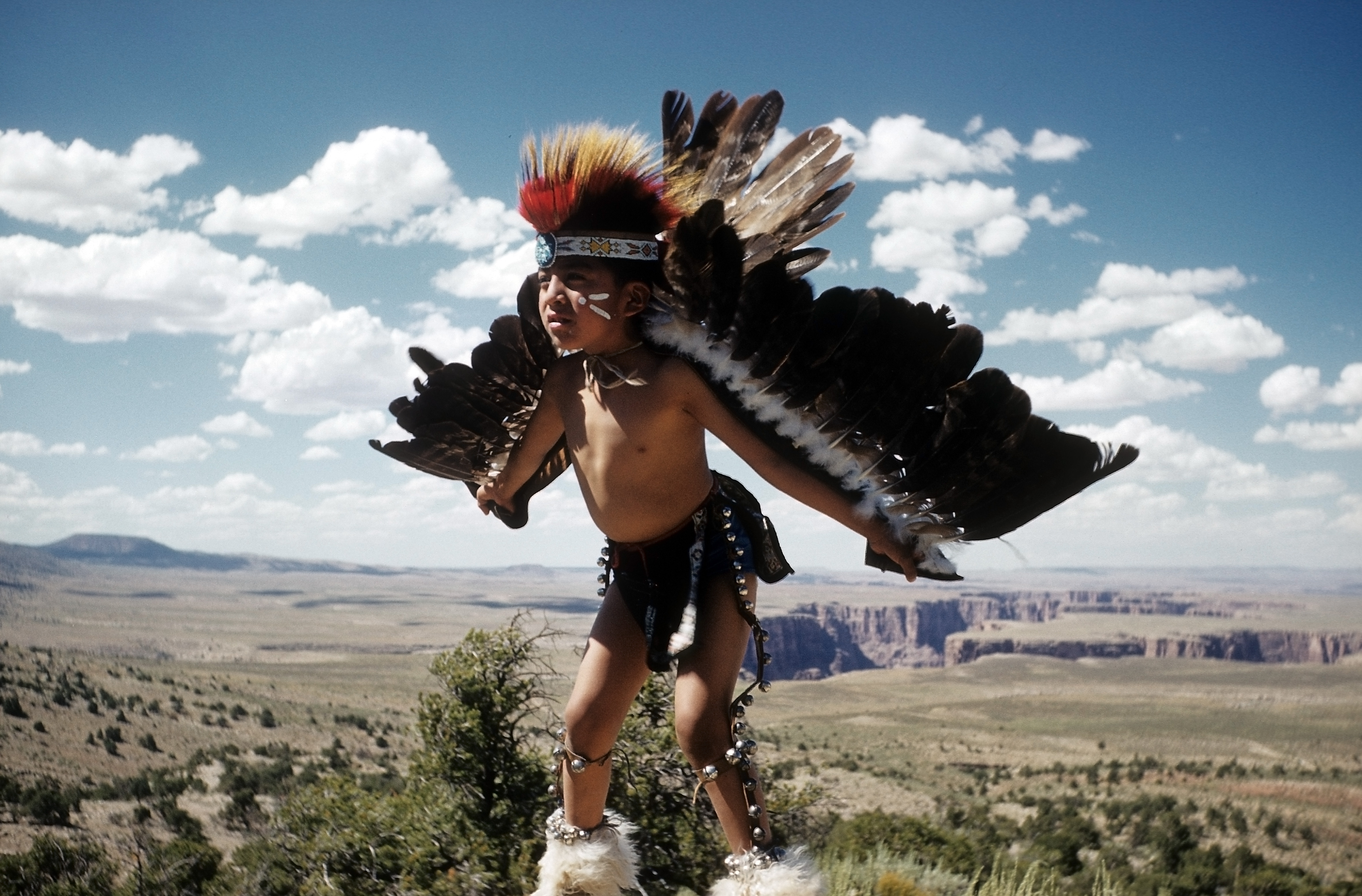 ARIZONA - JUNE 1952: A young Native American boy learns the Eagle Dance in Grand Canyon National Park, Arizona.