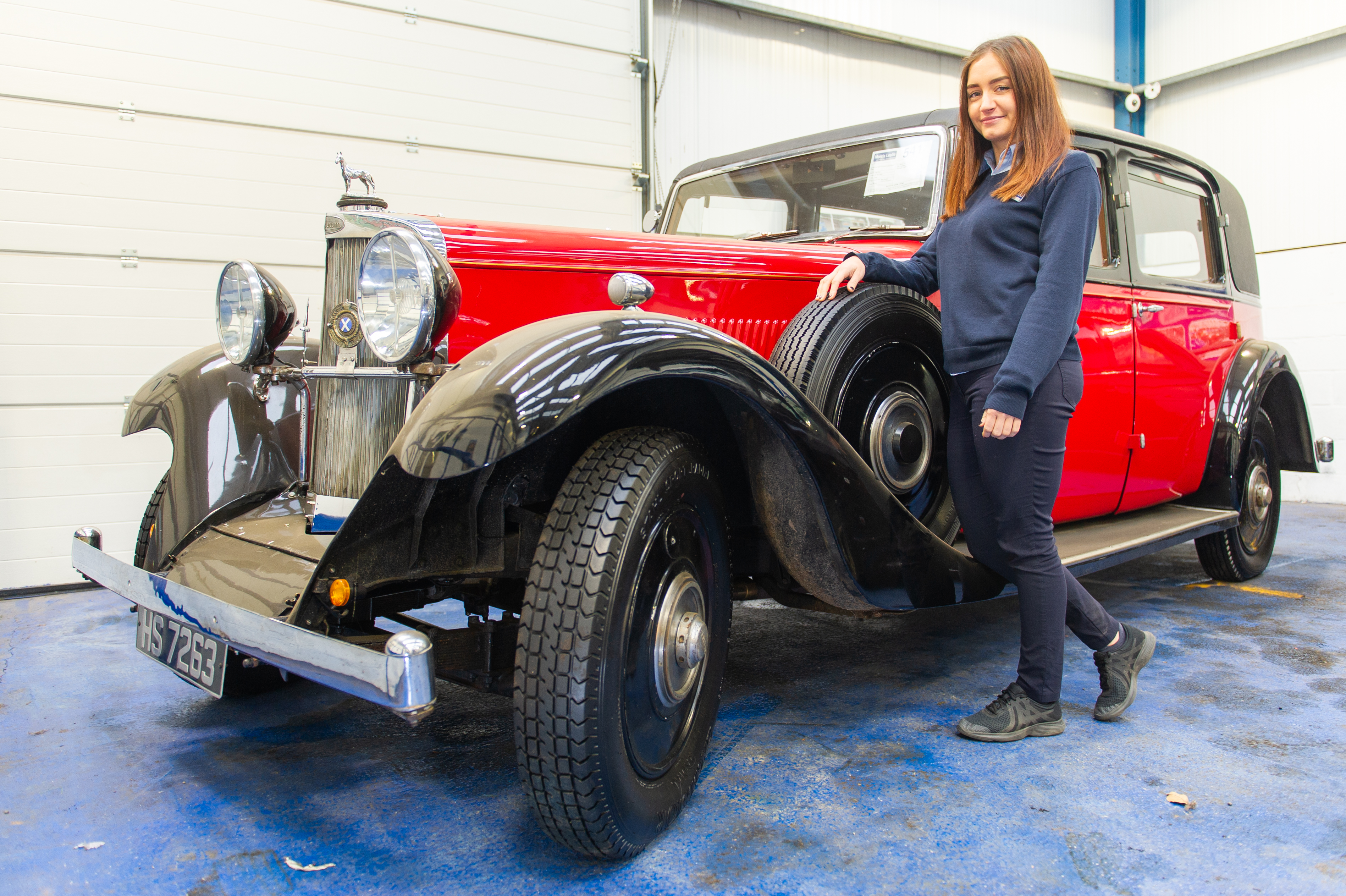 Auction administrator Jade Bloomer with the 1933 Sunbeam 25 Limousine