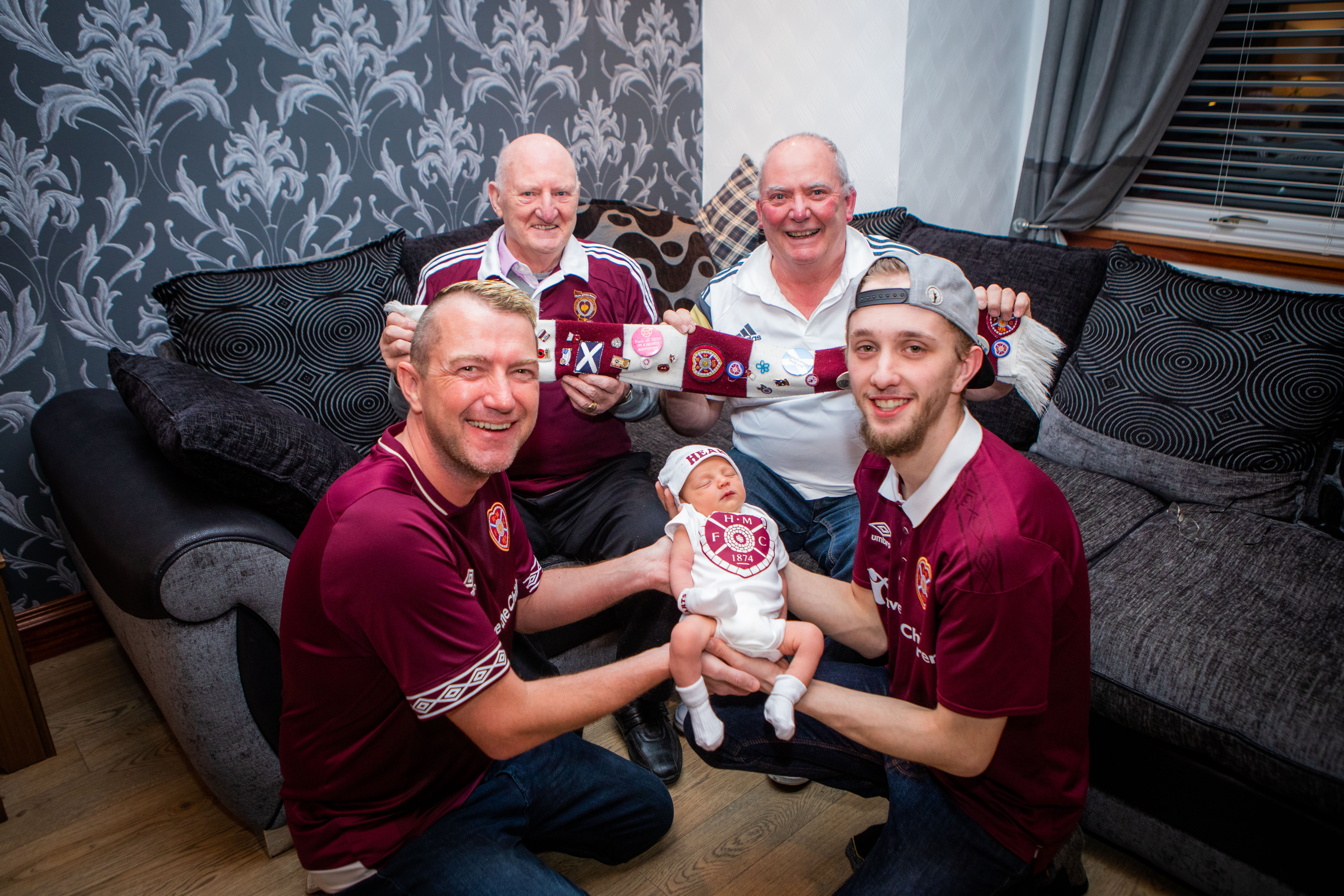 High five - Baby RJ, being held by dad Titch Jr (right), grandad Titch (left) and great grandad Ricky (back right) and great great grandad Dick (back left)
