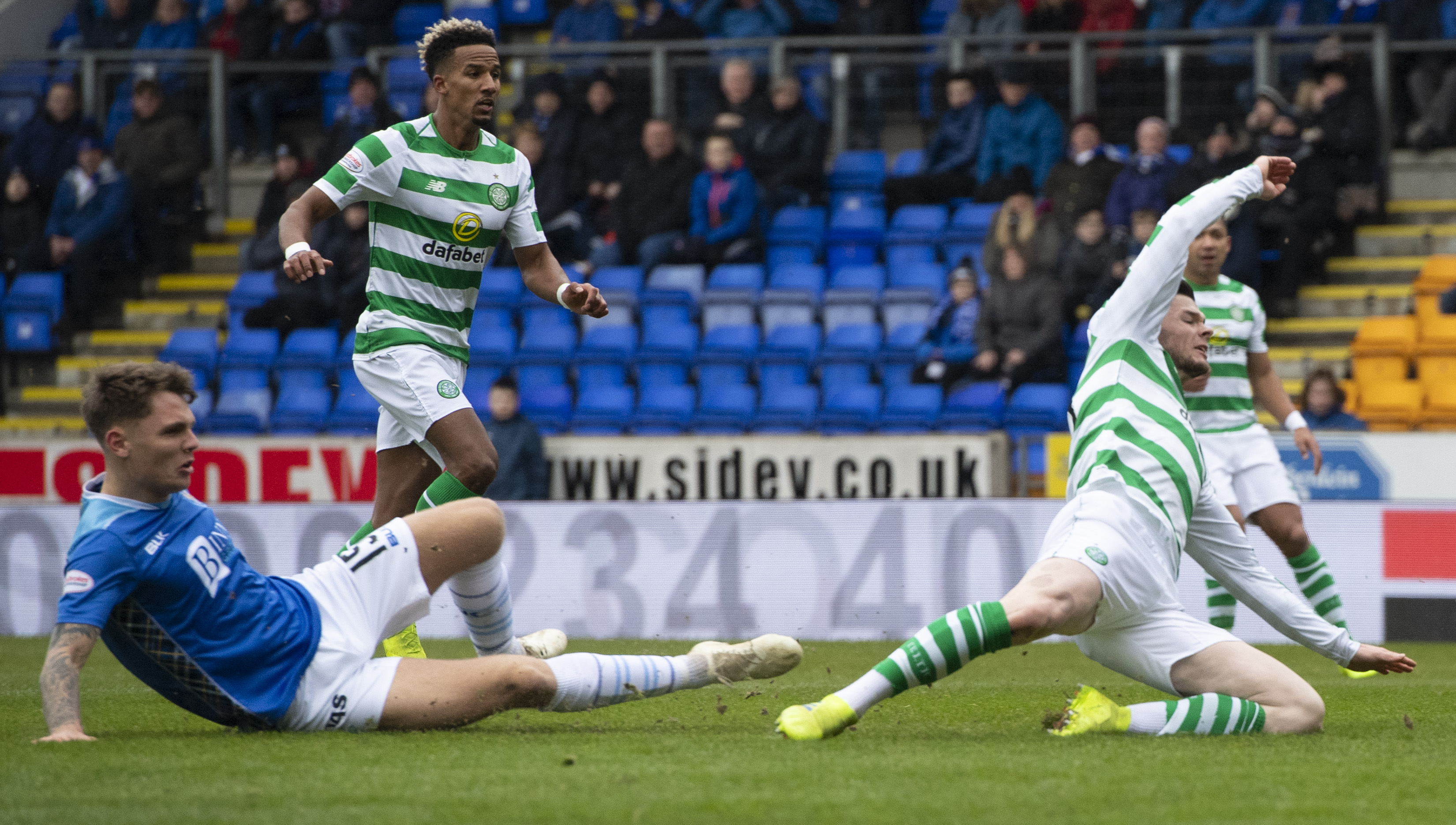 Jason Kerr challenges Ollie Burke at Celtic's penalty claim.