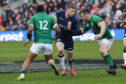 Finn Russell takes on Ireland's Bundee Aki (left) and Cian Healy.