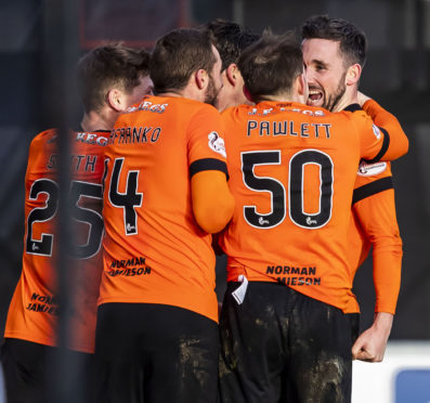 United's players celebrate Nicky Clark's winning goal at Paisley.