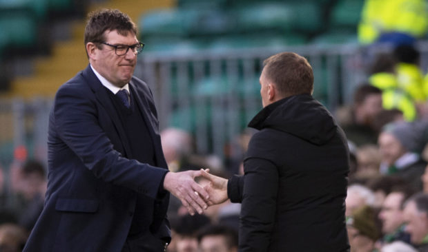 Tommy Wright skaes hands with Brendan Rodgers at full-time.