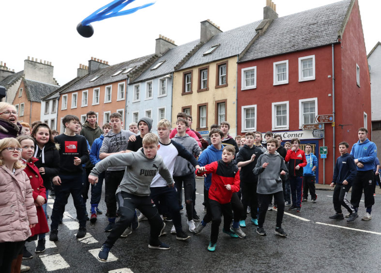Boys chase the leather ball during the annual 'FasternÕs E'en Hand Ba' event on Jedburgh's High Street in the Scottish Borders.