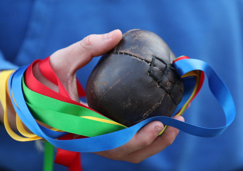 The leather ball is held during the annual 'FasternÕs E'en Hand Ba' event on Jedburgh's High Street in the Scottish Borders.