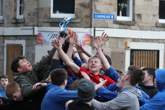 Boys tussle for the leather ball during the annual 'FasternÕs E'en Hand Ba' event on Jedburgh's High Street in the Scottish Borders.