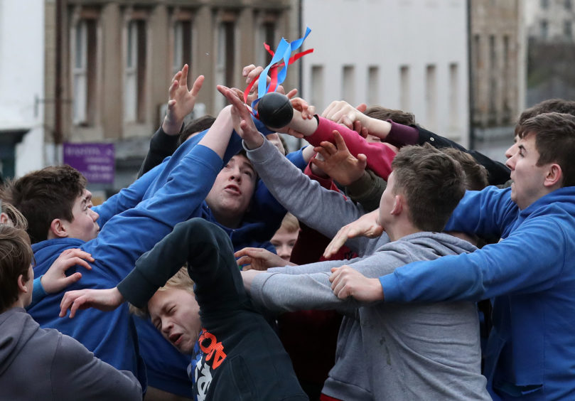 Boys tussle for the leather ball during the annual 'FasternÕs E'en Hand Ba' event on Jedburgh's High Street in the Scottish Borders.