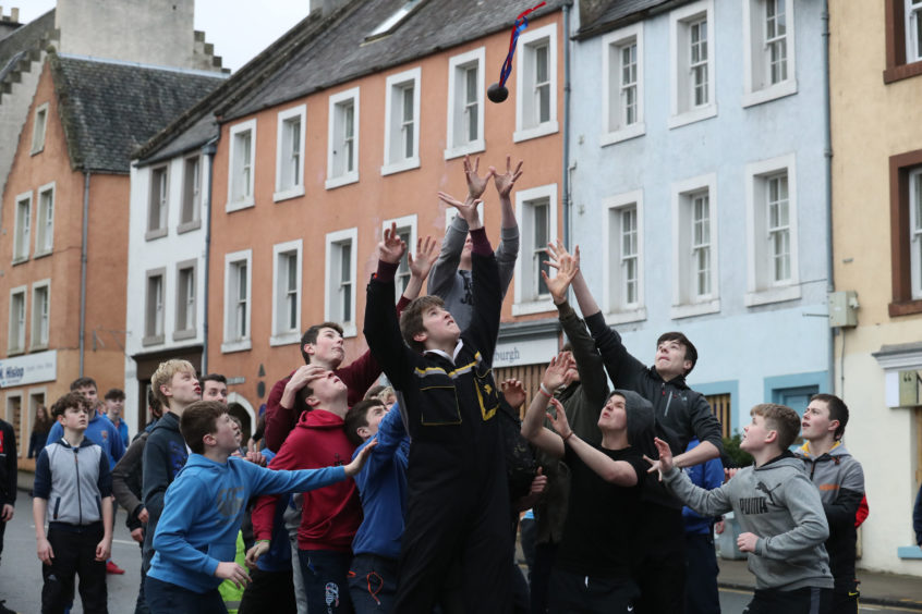Boys jump to catch the leather ball during the annual 'FasternÕs E'en Hand Ba' event on Jedburgh's High Street in the Scottish Borders.