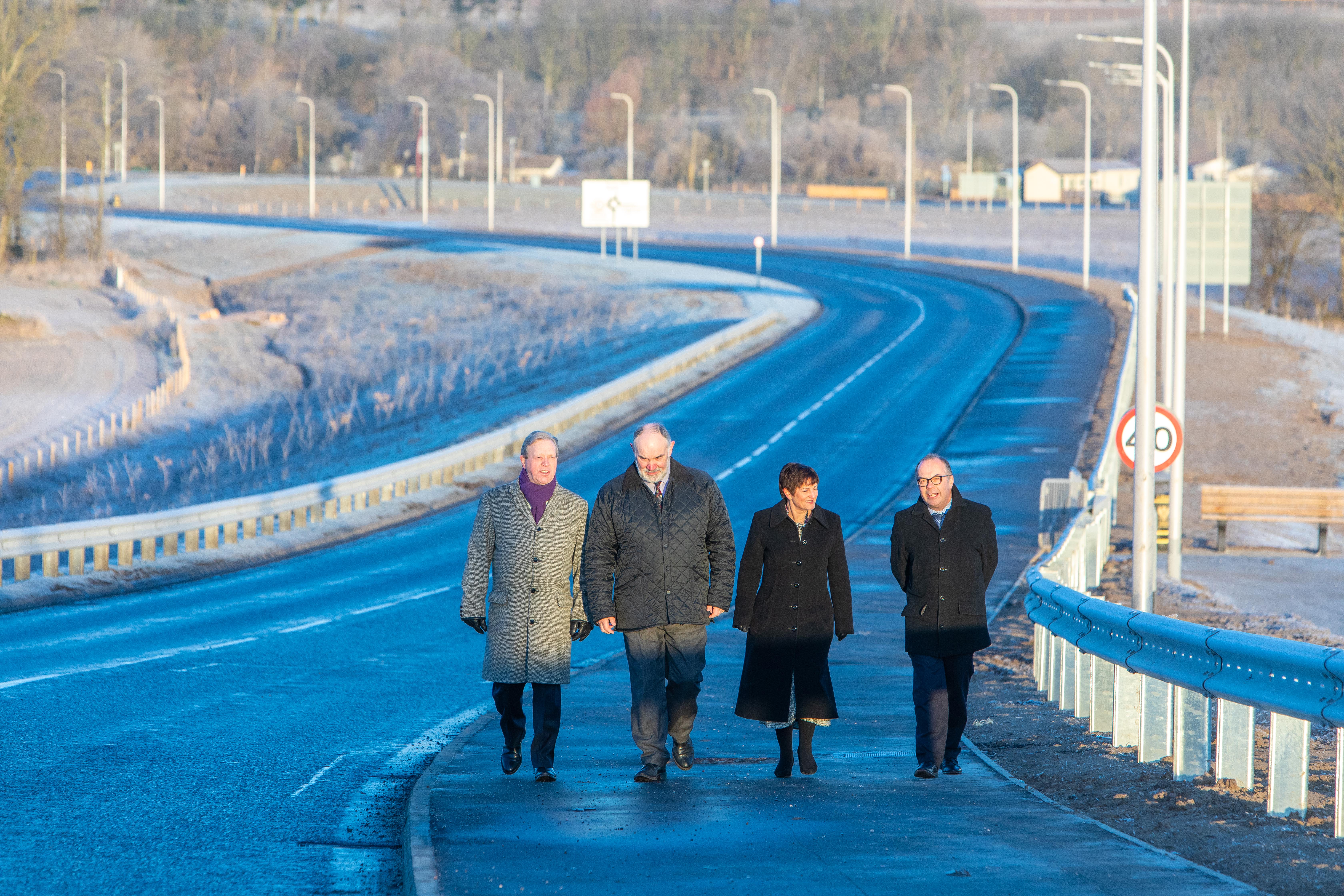 Peter Porteous, Cllr Murray Lyle, the council's Karen Reid and Stephen Scott of Balfour Beatty walk the path of newly opened section of A85.