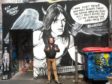 Ben Scott pictured next to Malcolm Young graffiti in AC/DC Lane in Melbourne, Australia