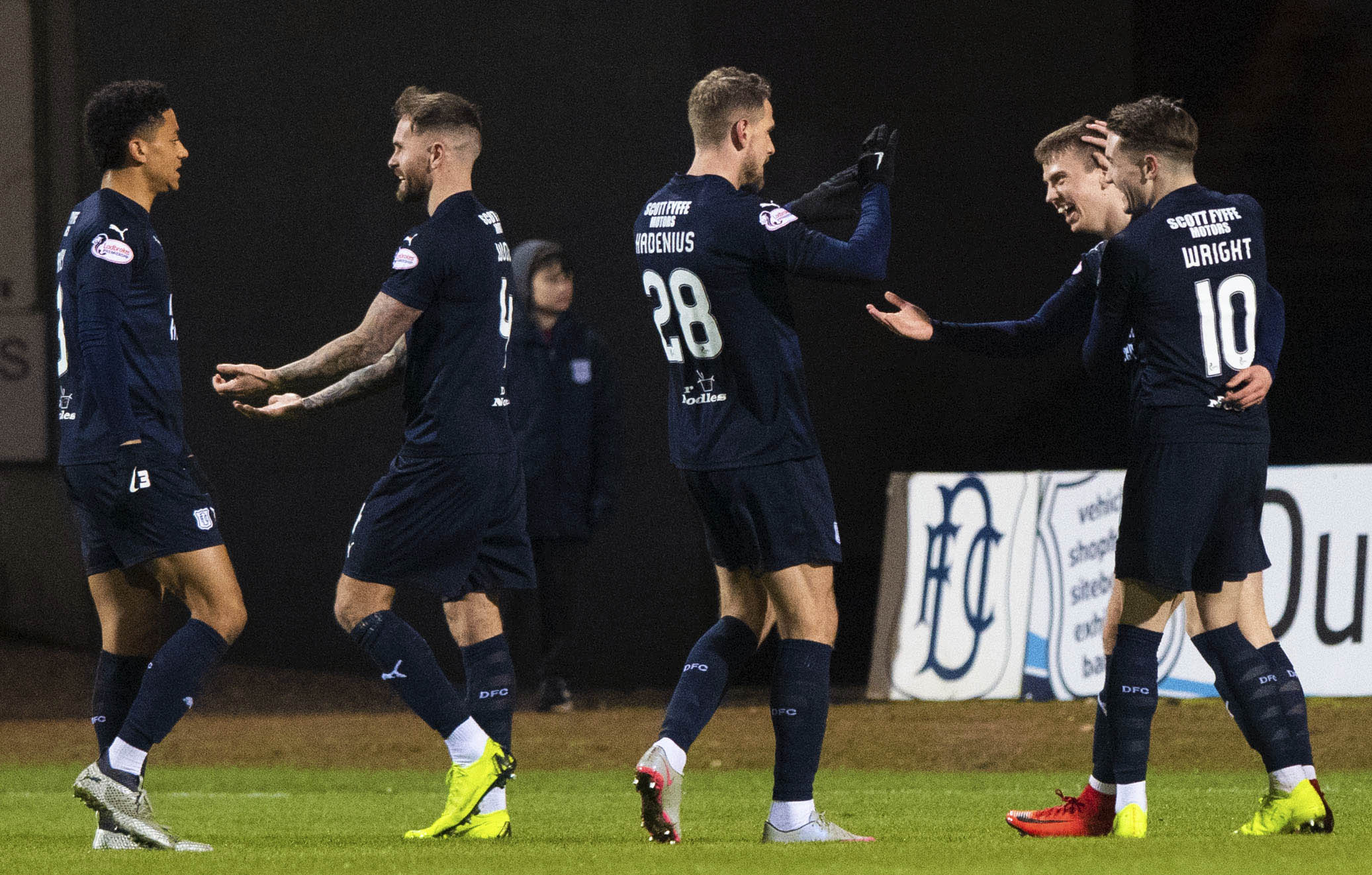 The Dundee players celebrate Andrew Nelson's (R) opener.
