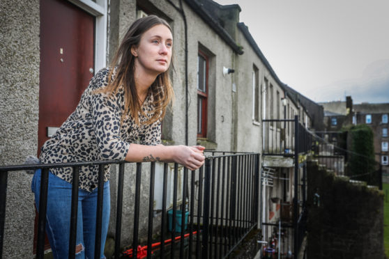 Private tenant Emma Barry outside her flat, which is marked for demolition