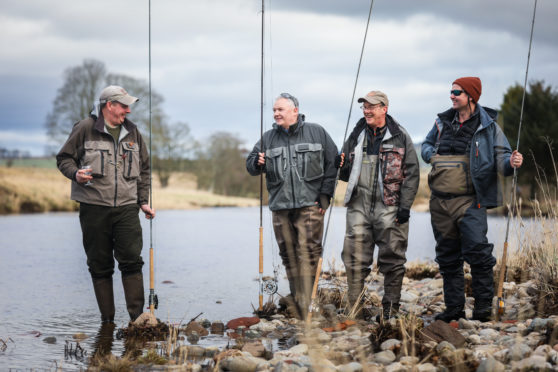 Neil Anderson, Manager of Gallery Fishings with Joe Gorman, Grant Kellie and Alan Greene bless the river with whisky to open the season. a
