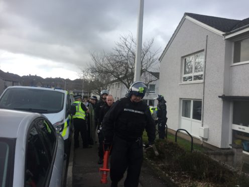 Police officers leaving the scene at Restenneth Drive on Wednesday.