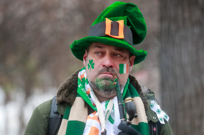 A participant in a parade marking Saint Patrick's Day in Sokolniki Park.