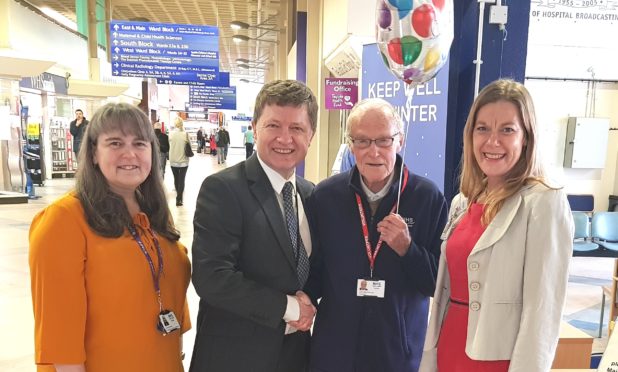 John MacGillivray is congratulated by fundraising support officer Lorna Donnelly, chief executive Grant Archibald and clinical governance and risk management team leader Tracey Passway.
