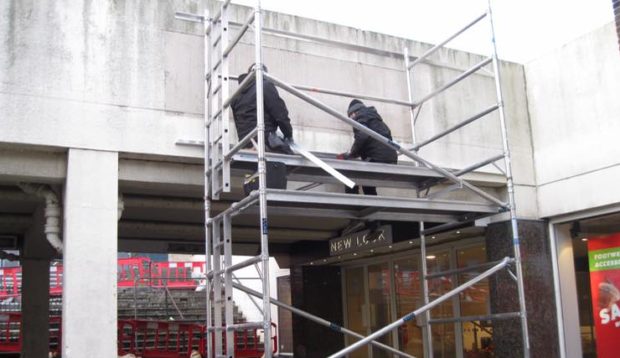 Workmen removing the old signs ahead of the 'Kirkcaldy Centre' revamp.