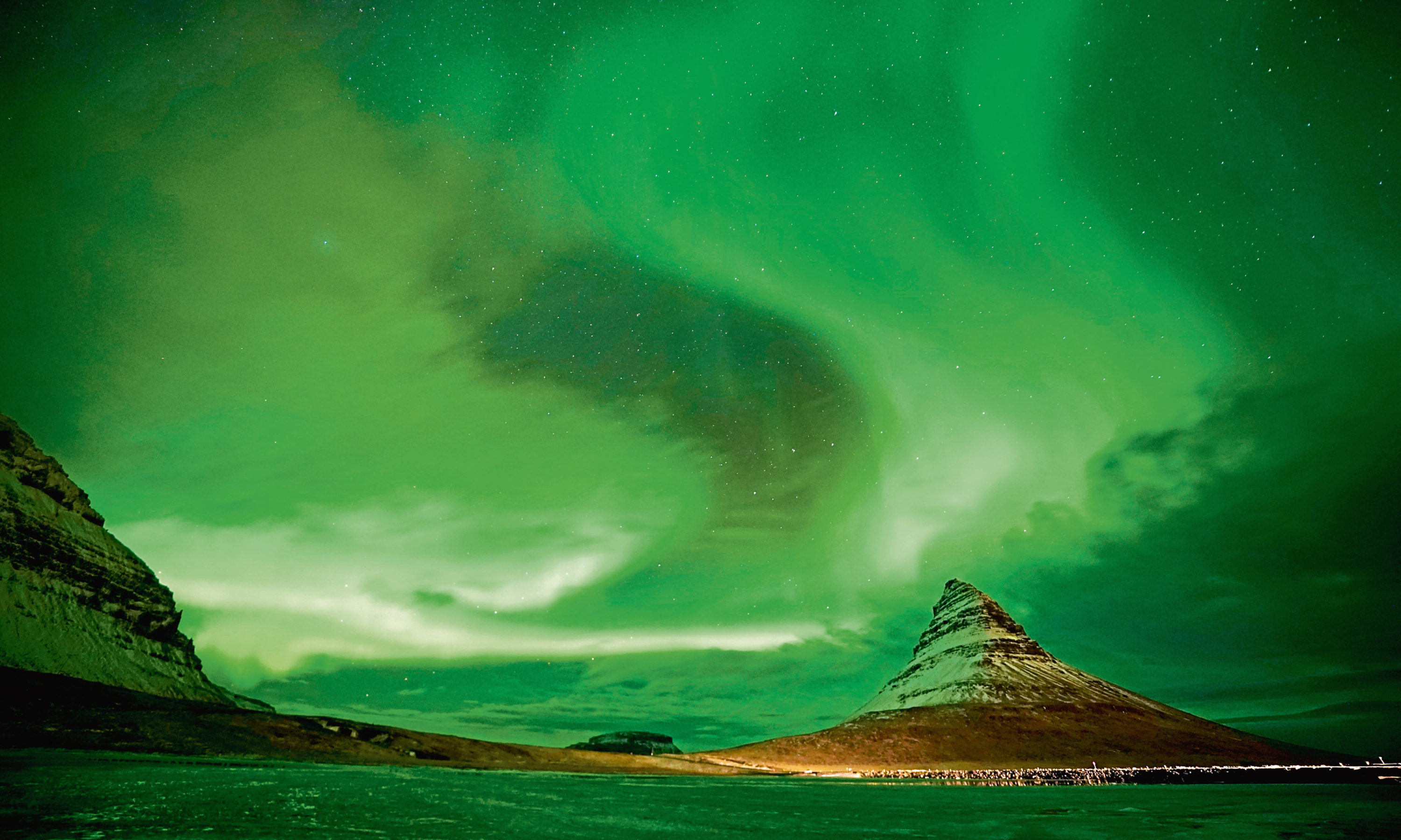 Aurora Borealis, the Northern Lights, over Kirkjufell, a 463 metre mountain on the west coast of Iceland.