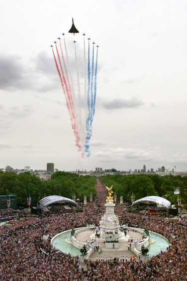 A Concorde and the Red Arrows above The Mall as part of the celebration to mark the Golden Jubilee of Queen Elizabeth II.