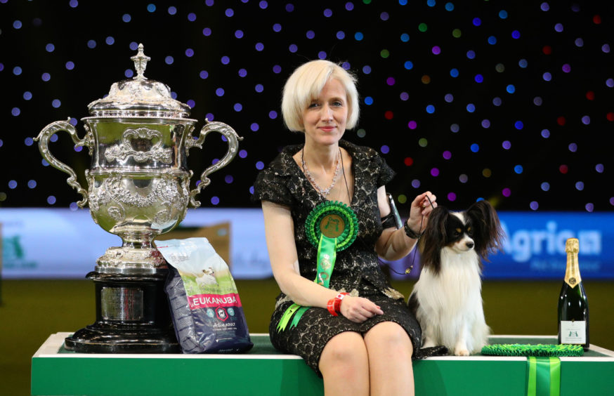 Dylan, a Papillon from Belgium, with owner Kathleen Roosens after winning the best in show during the final day of the Crufts Dog Show 2019 at the NEC in Birmingham.
