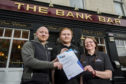 Licensees Paul and Susan Russell with Paul's son Ciaran Russell - who is the bar manager - in the centre.
