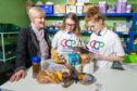 Brechin Pantry chairperson Kathy Calderwood wirh Mearns Academy S3 pupils Iris Calderwood and Erin Hair