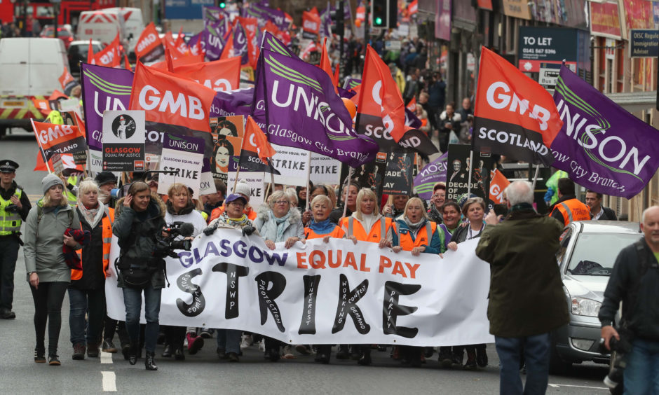 Strikers march to Glasgow Council's city chambers for a mass rally during a 48 hour strike by 8,000 GMB and Unison members over an equal pay claim.