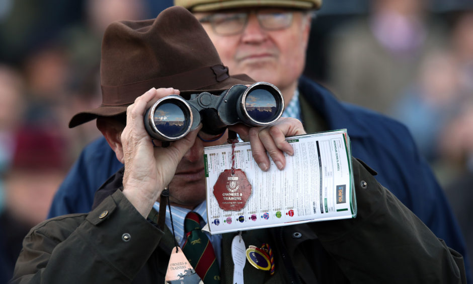 A spectator watches the action. Andrew Matthews/PA