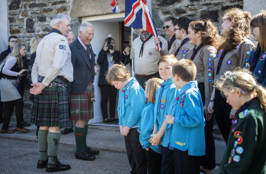 The Prince of Wales meets scout leaders and members during a visit to the newly refurbished 1st Macduff Scout Hut in Macduff.