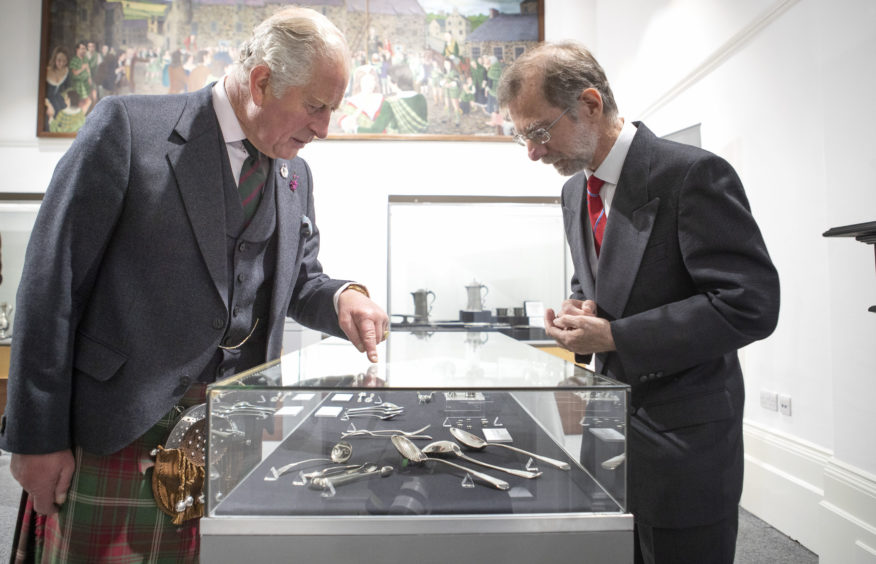 The Prince of Wales, known as the Duke of Rothesay while in Scotland, looks at display of Banff Silverware with Dr David Bertie (right) during a visit to the Banff Museum in Banff, Aberdeenshire.