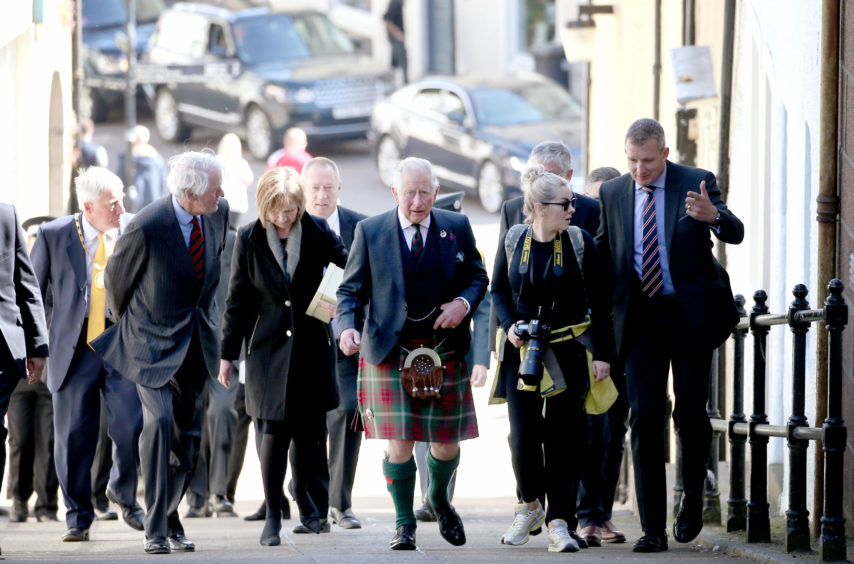 The Prince of Wales, known as the Duke of Rothesay while in Scotland, walks up the 'Strait Path' through Banff town centre before a visit to the Banff Museum in Banff, Aberdeenshire.
