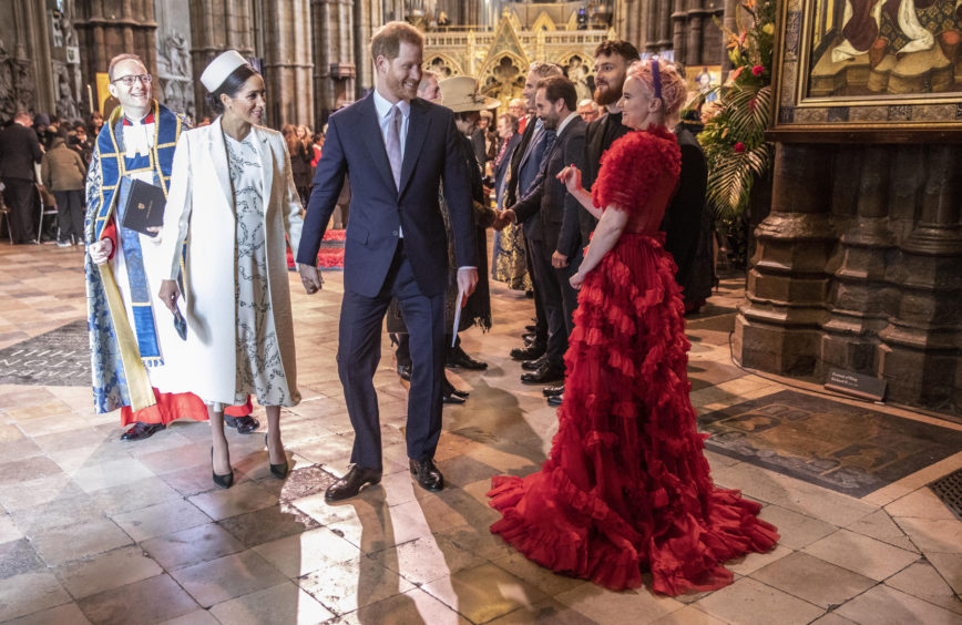 The Duke and Duchess of Sussex talk with Grace Chatto from the group "Clean Bandit" who performed at Westminster Abbey Commonwealth day service, London.