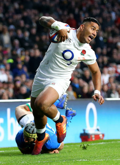 England's Manu Tuilagi scores his side's fifth try during the Guinness Six Nations match at Twickenham Stadium, London.
