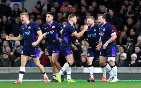 Finn Russell celebrates his try with team-mates at Twickenham during the 2019 Calcutta Cup.
