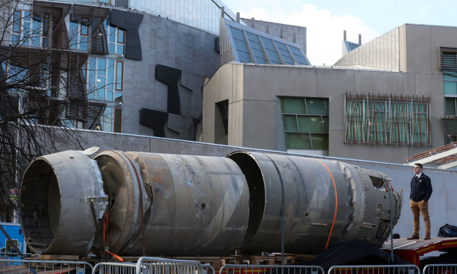 Owain Hughes views the Black Arrow rocket
outside the Scottish Parliament. It was brought home from the Australian outback by Scottish space firm, Skyrora, and was the only UK rocket to reach orbit.