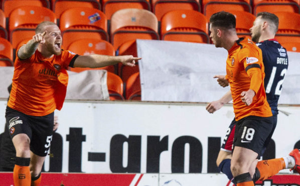 Dundee United's Mark Connolly celebrates with the goalscorer, Calum Butcher, after giving his side the lead.