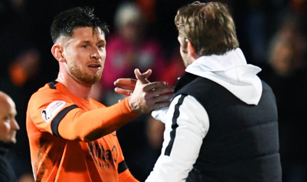 Dundee United manager Robbie Neilson congratulates matchwinner Calum Butcher at full-time.