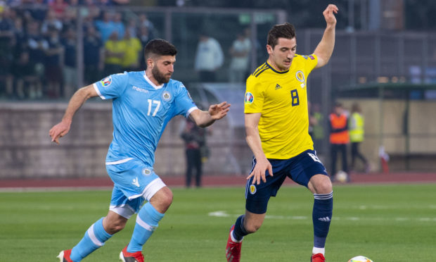 Scotland's Kenny McLean (right) skips away from San Marino's Enrico Golinucci.