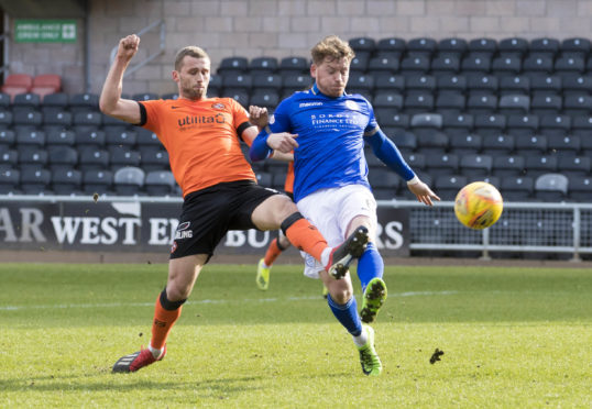 United's Pavol Safranko battles with opponent Michael Doyle.