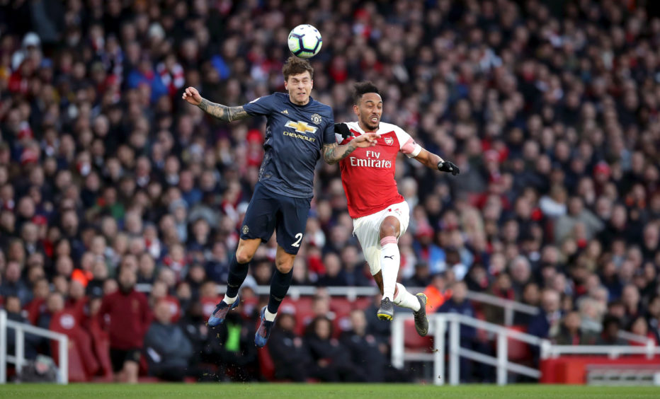 Manchester United's Victor Lindelof (left) and Arsenal's Pierre-Emerick Aubameyang battle for the ball during the Premier League match at the Emirates Stadium, London.
