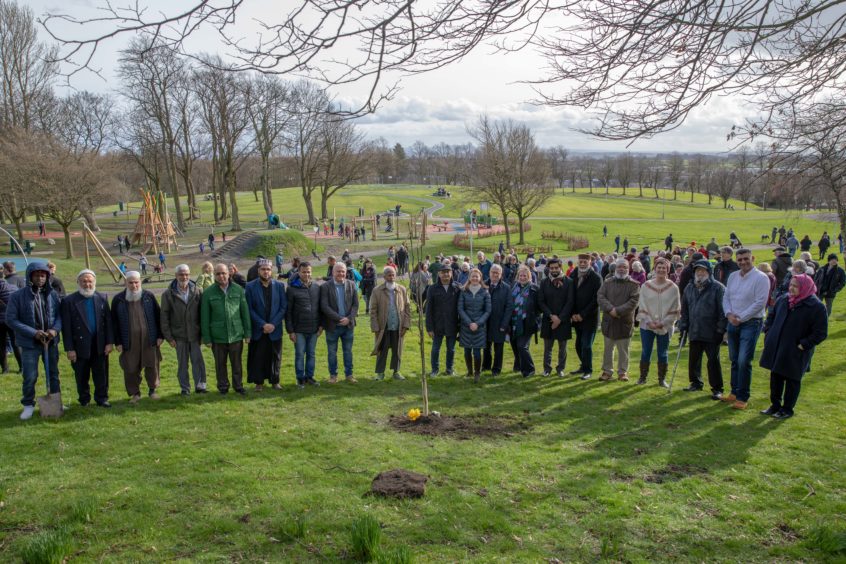 All faiths and creeds stand together by the Peace Tree in Dunfermline.