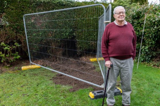 Mr Holmes in the fenced off polluted area of his garden