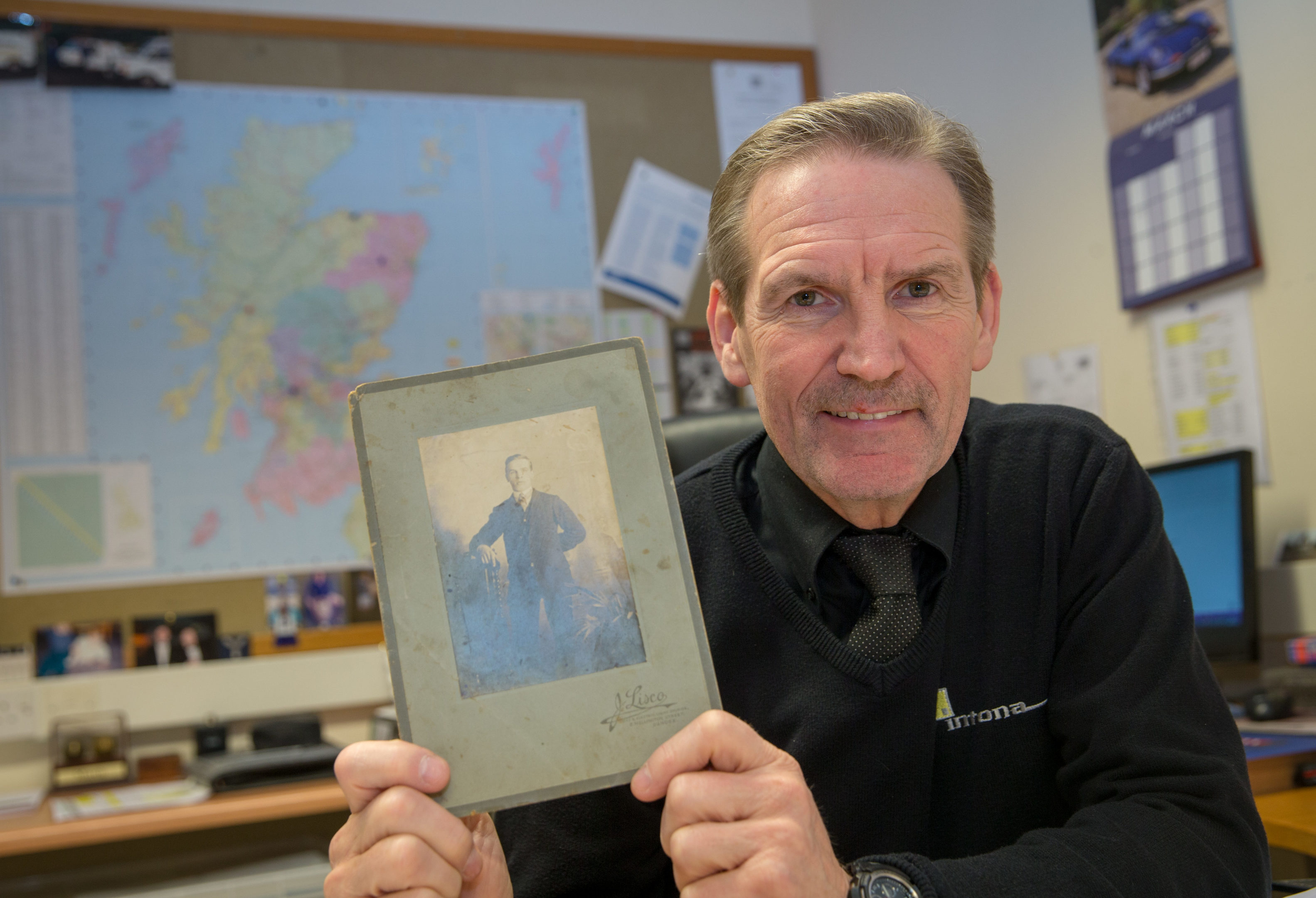 Ron Mitchell the boss of Dundee firm Intona holds a  photograph of his late grandfather William Orchiston who lost his leg at the Somme in 1916.