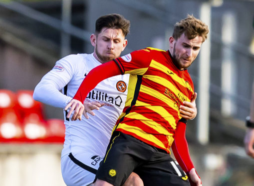 Calum Butcher battles for the ball.